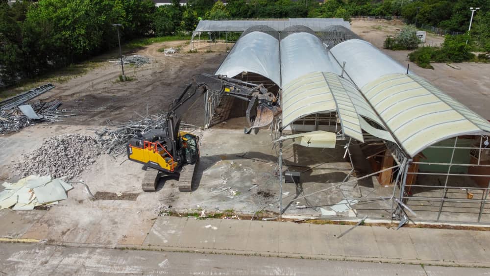 Excavator rental demolishing a building